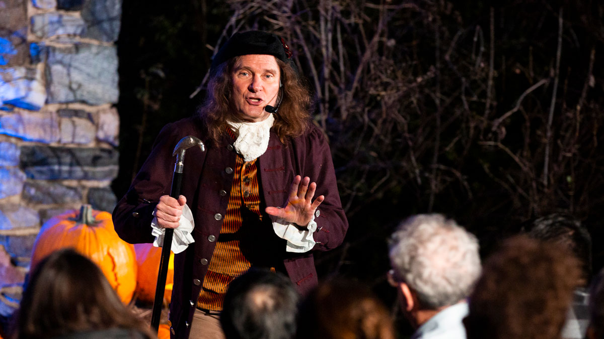Storyteller in colonial dress in front of audience