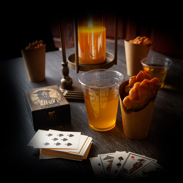 Table at The Gourd & Goblet Tavern Table at The Gourd & Goblet Tavern with beer, playing cards, and snacks